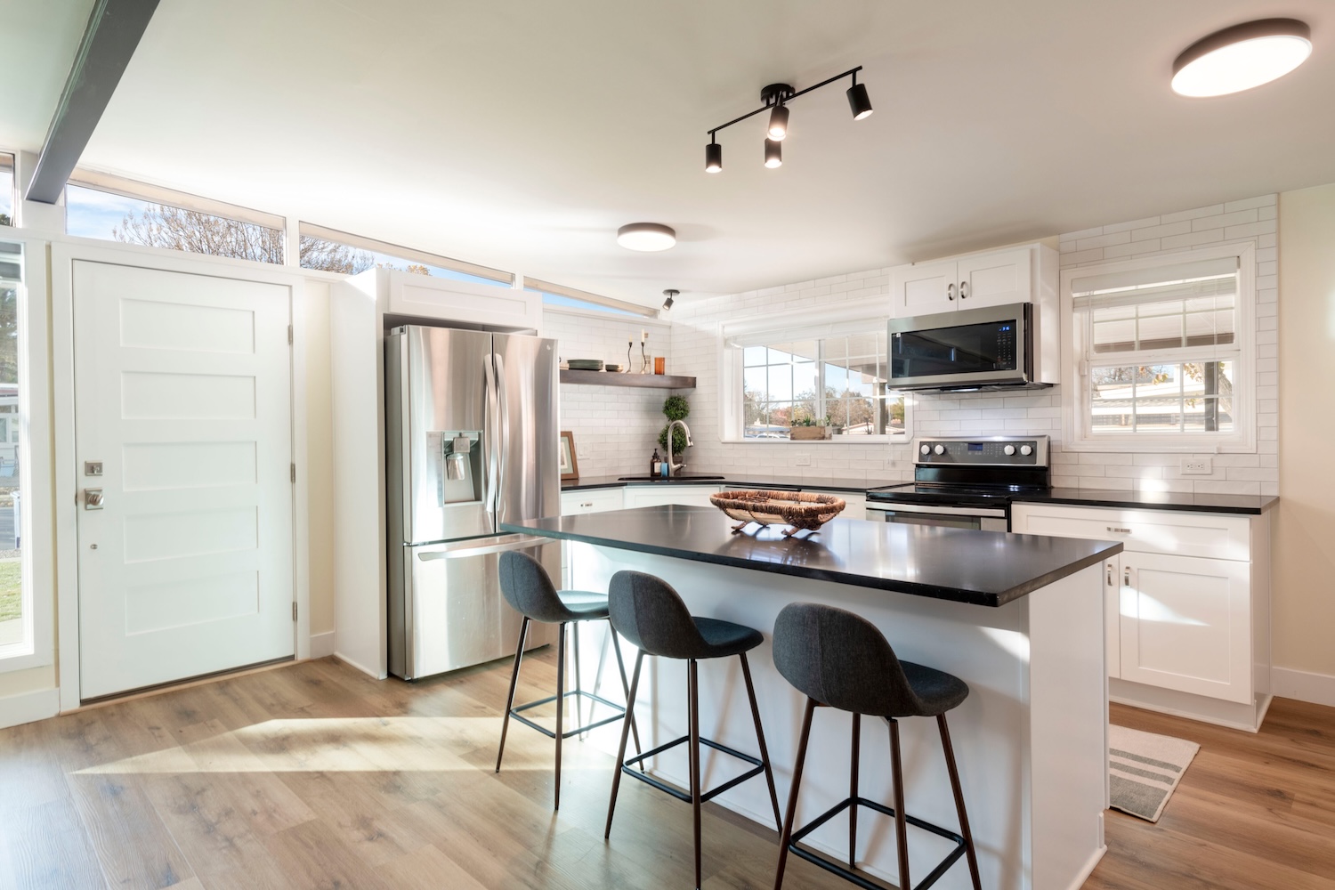 Kitchen with refrigerator, stove, microwave, cabinets, and other fixtures and personal property in a home sale.